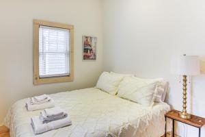 a bedroom with a bed with towels on it at Walk to Shops and Dining Cozy Osterville Cottage in Osterville