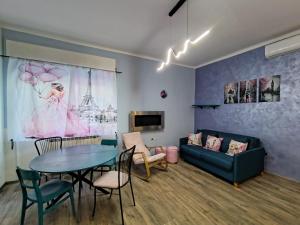 a living room with a table and a couch at L'angolo del Viaggiatore 5 Terre in La Spezia