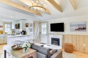 a living room with a couch and a fireplace at Walk to Shops and Dining Cozy Osterville Cottage in Osterville