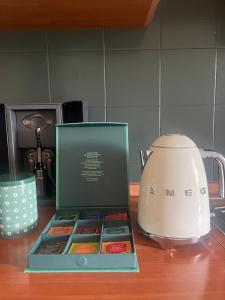 a box of colored candies next to a tea kettle at La Corte dei Prefetti di Vico Bellavista Relax in Ronciglione