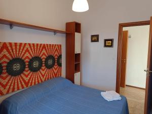 En eller flere senge i et værelse på Appartamento Scirocco