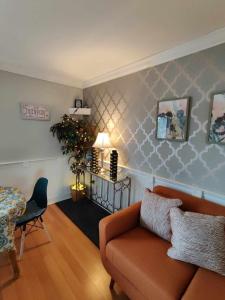 a living room with a couch and a table at Gilford Beachfront Stay, Pool, WiFi & Parking Incl in Laconia