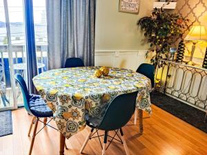 a dining room table with a cat sitting on top of it at Escape to a Modern Laconia Condo With Pool, Balcony & Free Parking! in Laconia