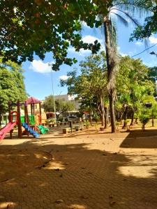 a park with a playground with trees at Conexão Mineira in Pedro Leopoldo +6 photos