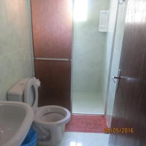 a bathroom with a shower and a toilet and a sink at Pousada Brasil Tropical in Ilha do Mel +53 photos