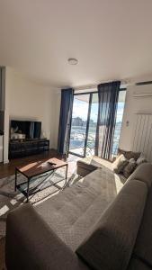 a living room with a couch and a table at Planet Residence Royal Studio & SPA in Niš