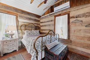 a bedroom with a bed and a wooden wall at Rustic Augusta Cabin in Augusta