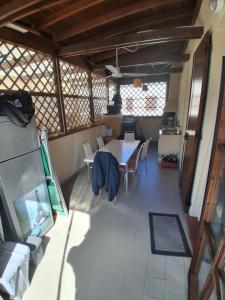 a kitchen and dining room with a table and chairs at Casa PC in Porto Corsini