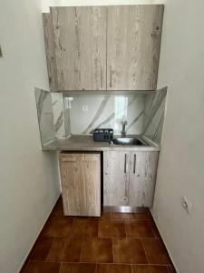 a small kitchen with a sink in a room at Aris Paschalia Studios in Argyrádes +31 photos