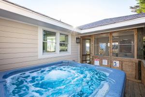 a hot tub sitting outside of a house at New Listing Semi Ocean Front with Pool & Hot Tub in Duck