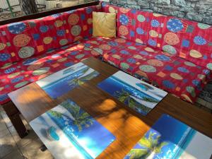 a couch with a table with pictures on it at Pinehouse Velipoja in Velipojë