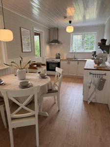 a kitchen with a table and chairs in a room at Hus Björklund in Hällefors
