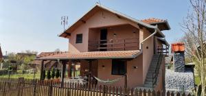 a small house with a fence in front of it at Vikendica Pavlović in Zatonje