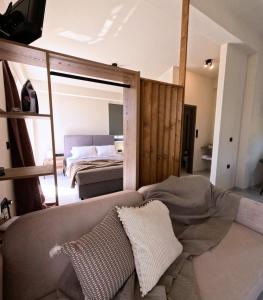 a living room with a couch and a bed at Dris Suites in Nikiana