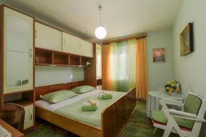 a bedroom with a bed and a table and a chair at Rooms Mirjana in Trogir