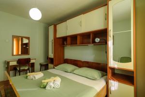 a bedroom with a bed with towels on it at Rooms Mirjana in Trogir