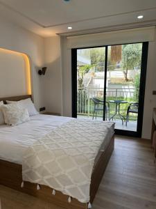 a bedroom with a bed and a balcony with a table at Oregano Side in Side +48 photos