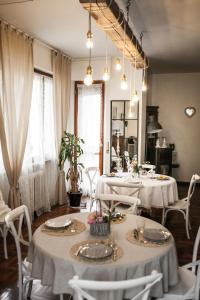 a dining room with two tables and white chairs at B&B Villa Ngiolò "vista mare" in Ancona