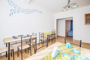 a dining room with tables and chairs in a room at casa Ferrigno in Vietri sul Mare +70 photos