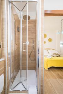 a glass shower in a bedroom with a bed at casa Ferrigno in Vietri sul Mare