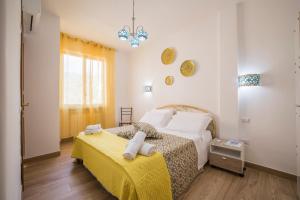 a bedroom with two beds and a yellow blanket at casa Ferrigno in Vietri sul Mare