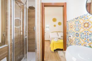a bathroom with a shower and a bedroom at casa Ferrigno in Vietri sul Mare