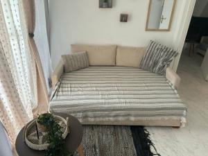 a couch in a living room with a hat at Cozy apartment comfy 1 in Serres