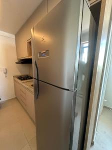 a stainless steel refrigerator in a kitchen at Flat Carneiros Tamandaré Kauai beach in Tamandaré