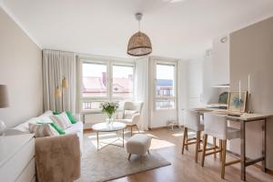 a living room with a couch and a table at Stylish Studio Apartment - Center in Stockholm