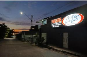 a building with a sign on the side of it at Pousada e Restaurante Kero Kero in Conceição do Araguaia