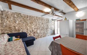 a kitchen and dining room with a table and chairs at Nice Home In Tisno With Wifi in Tisno