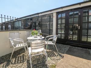a patio with a table and chairs and a building at Maritime Mews, 6 The Oakleys in Porthmadog