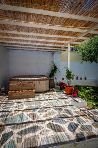 acovered patio with a couch and a rug at Skiathos Pearl in Skiathos