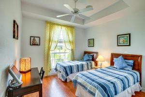 a bedroom with two beds and a window at Pool, Spa and Dock Waterfront Tarpon Point Home in Cape Coral +20 photos