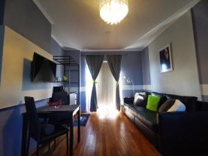 a living room with a couch and a table at M3 Green Oasis Mogyoród in Mogyoród