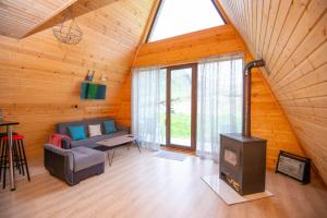 a living room with a stove in a wooden house at MOUNTAIN CABIN in Ushguli