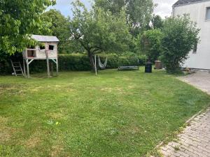 a yard with a playground and a swing at Ferienwohnung Am Wasen in Pleinfeld