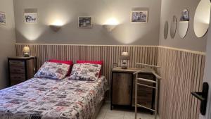 a bedroom with a bed with red pillows at villa vue mer avec piscine et jardin arboré in Coggia +22 photos