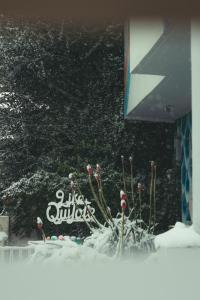 a cake with snow on it in front of a building at Hostel Like Quijote in San Carlos de Bariloche