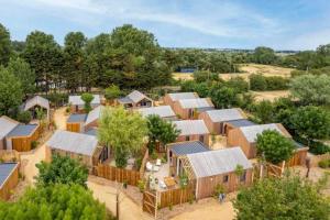 an aerial view of a farm with wooden buildings at Camping 4 étoiles - Piscine - cbgcaig in Notre-Dame-de-Monts