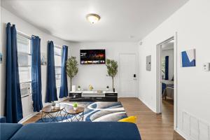 a living room with a blue couch and blue curtains at Fun Family getaway - NYC & NWK w free parking in Newark