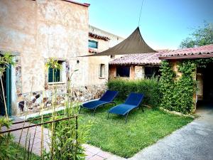 two blue chairs in the yard of a house at La Lechería de Daniela in Granja de Moreruela +7 photos