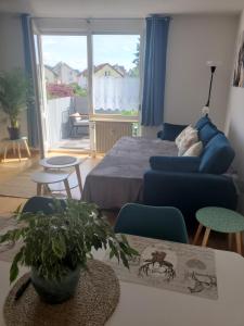 a living room with a bed and a couch at Apartament Klara7 in Herbolzheim