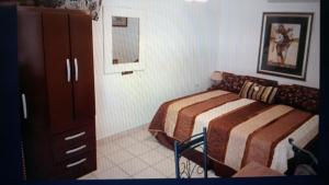a bedroom with a bed and a dresser in it at Chez Lilly in Oranjestad +18 photos