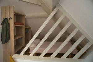 a staircase in a room with a bunk bed at ZEcamping 4 étoiles pataugeoire piscine chiens acceptés tente 25m2 in Meyronne