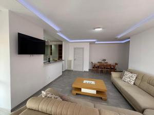 a living room with a couch and a table at Ami Apartment - WI-FI in Tortoreto Lido