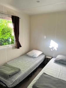 Rúm í herbergi á Camping 2 étoiles - ccbabhg