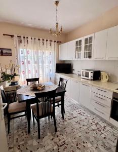 a kitchen with a table and chairs in a kitchen at Ela guest house in Vlorë