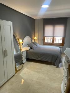 a bedroom with a bed and a window at Apartamento Marisol in Alcañiz