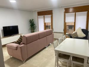 a living room with a couch and a table at Apartamento Marisol in Alcañiz